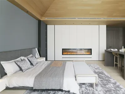 A modern minimalist bedroom featuring a hidden fireplace, a large bed with white linens, and a wooden floor.