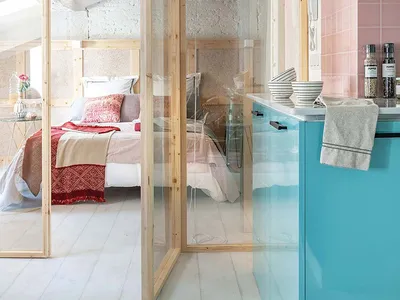 A modern kitchen with pink tiles and wooden finishes, showcasing contemporary design.