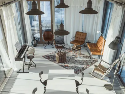 A modern industrial living room with marble flooring and mixed-media decorative accents.