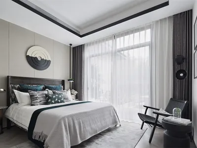 Modern minimalist bedroom with fabric bed, wood floor, and glass window.
