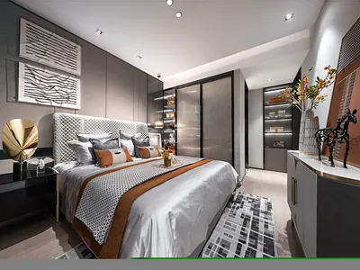 A modern bedroom showcasing fabric bedding, metallic accents, and glass elements.