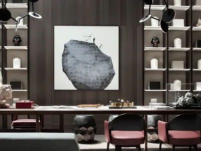 A modern home office featuring a large bookshelf, desk, and seating area with a minimalist and stylish design.