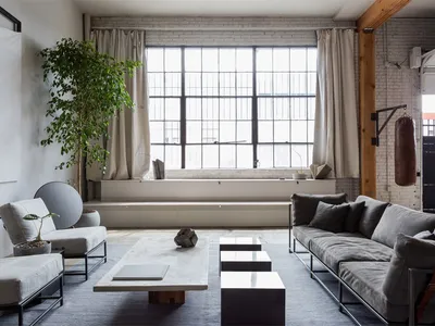Industrial living room featuring concrete and wood elements.