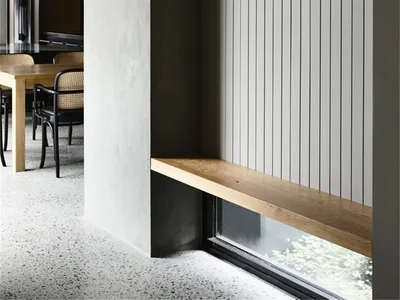 Industrial-style restaurant interior featuring concrete, wood, and metal elements.
