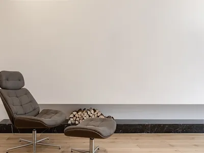 A modern interior design featuring a marble counter and wooden floor.
