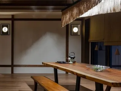 A contemporary dining room with mixed-media materials and design elements.