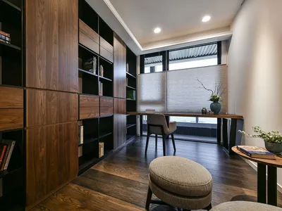 A modern contemporary home office with a wooden wall and floor, featuring a desk and chair setup.
