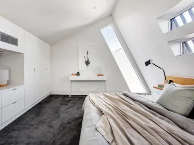 Modern white bedroom with concrete furniture and grey carpet