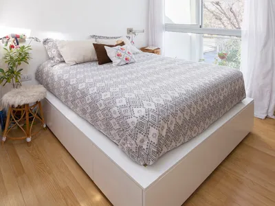A minimalist bedroom featuring modern materials and design.