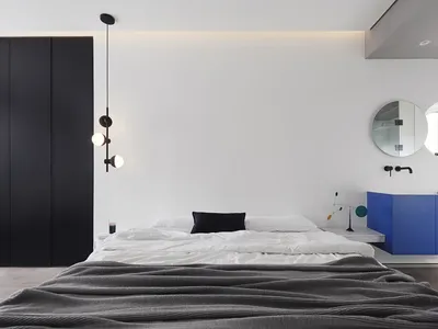 Modern bedroom featuring a minimalist design with metal accents.