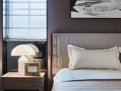 Modern bedroom with a fabric bed design featuring brown accents and a minimalist aesthetic.