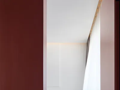 Modern minimalist bedroom with vertical space utilization, white bedding, and minimalistic design.