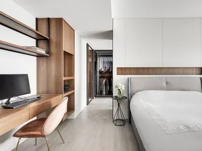 A minimalist bedroom with wooden furniture and a clean, modern design.