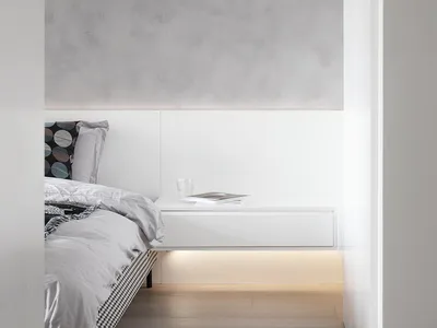 Minimalist bedroom with cement walls and floating nightstand with under-lit shelf, white bedding, and checkered footboard.