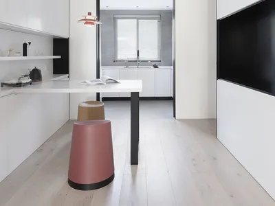 Modern minimalist kitchen featuring white laminate cabinets and stainless steel appliances.