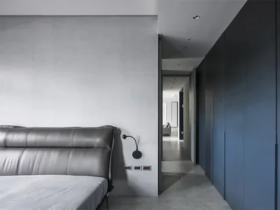 Modern bedroom featuring concrete and metal materials.
