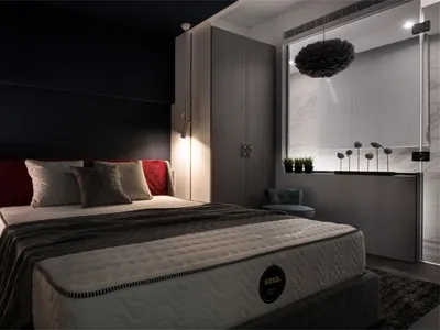 A modern bedroom featuring dark decor, a comfortable bed, and a sleek wardrobe.