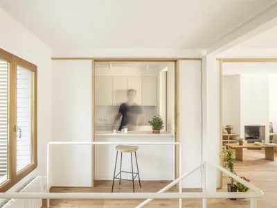 Minimalist residential kitchen featuring wood flooring and minimalist cabinetry.