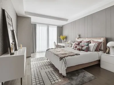 Modern minimalist bedroom with light-colored furniture, soft textiles, and contemporary design elements.