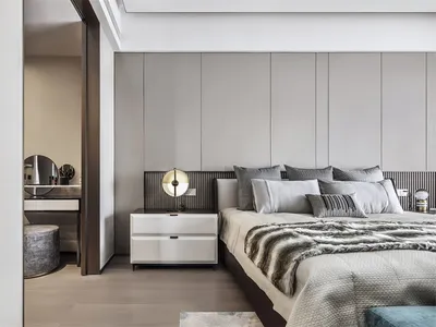 Modern bedroom with neutral tones and minimalist design.