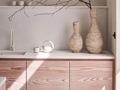 Modern kitchen with scallop-patterned cabinets and organic vases.