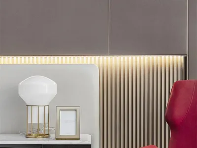 A sleek, minimalist desk with a red armchair.