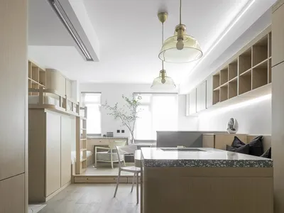 Modern kitchen with a combination of marble, terrazzo, and wood finishes.