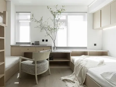 A minimalist bedroom featuring modern materials and furniture.