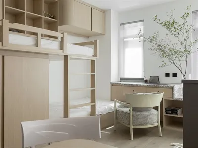 A modern minimalist bedroom featuring wooden furniture and a bunk bed.