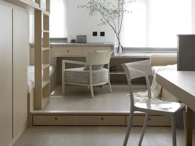 Minimalist bedroom featuring wood furniture and natural light.