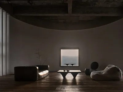 A minimalist living room with concrete furniture and a large window overlooking a serene landscape.