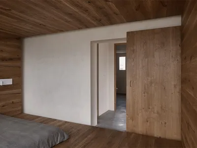 A minimalist bedroom featuring wood-paneled walls and a carpeted floor.
