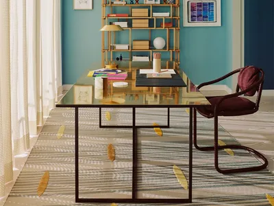 A minimalist home office with a transparent glass and metal desk, a wooden bookshelf, and a maroon chair.