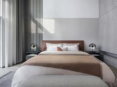 A minimalist bedroom with a neatly made bed, soft lighting, and a sleek, modern design.