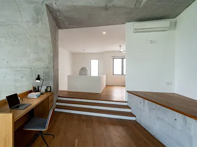A modern home office space featuring concrete and wood elements, designed for functionality and style.