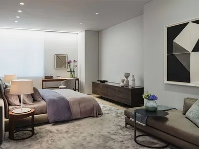 Contemporary bedroom featuring a clean, simple design with a wooden bed frame and a plush rug.