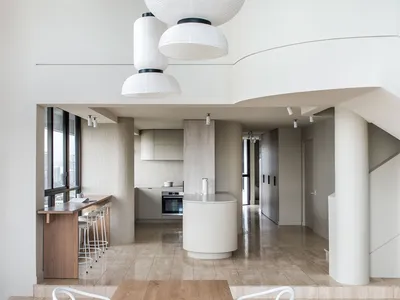 Modern, minimalist kitchen featuring wooden materials and clean lines.