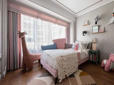 Modern child's bedroom featuring plush toys, a pink bed, and various animal-themed plush objects.