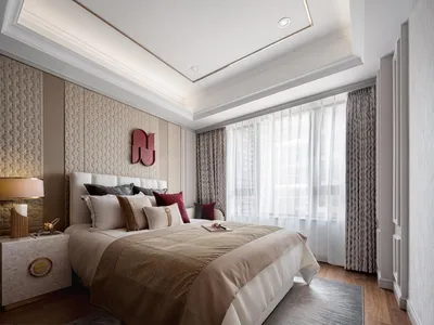 A modern bedroom featuring neutral-toned fabrics and textured wall paneling.