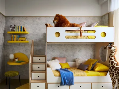A modern children's bedroom with a bunk bed, plush toys, and colorful bedding.