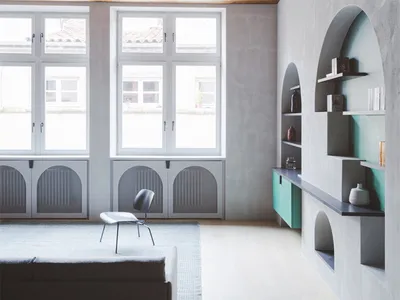 A minimalist living room with concrete walls and wooden ceiling beams.