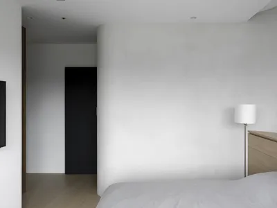 Minimalist bedroom featuring concrete walls and floor, simplicity and modernity