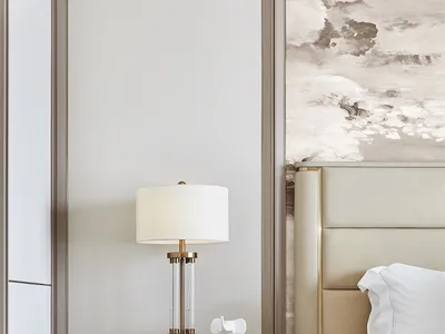 A minimalist bedroom with a large bed, nightstand, and lamp, featuring modern materials and a serene atmosphere.