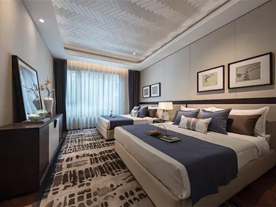 Contemporary bedroom with neutral-colored fabrics and modern lighting.