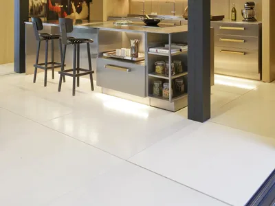 Modern kitchen with metallic island, wooden cabinets, and stainless steel appliances