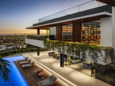 Modern stone spa lounge featuring modern wooden furnishings and glass walls, set against a serene outdoor setting with toweri