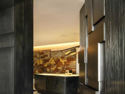 Modern hotel reception area with metallic and leather accents