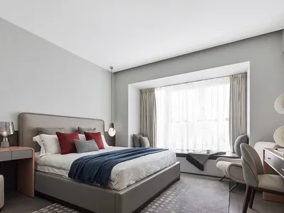 A modern bedroom featuring contemporary furniture and minimalist decor.