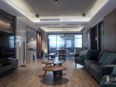 A modern industrial living room with exposed brick walls and wooden furniture.