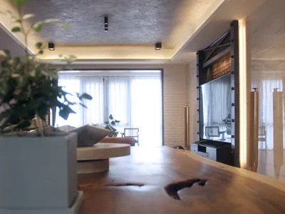 Modern industrial living room with wooden elements and a concrete wall.